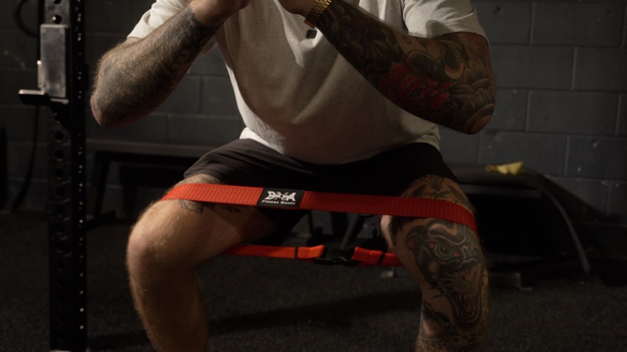 A DNA band buckled above the knees during a squat.